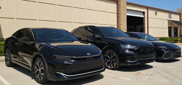 Three black vehicles parked in a row outside the ClearFlow building